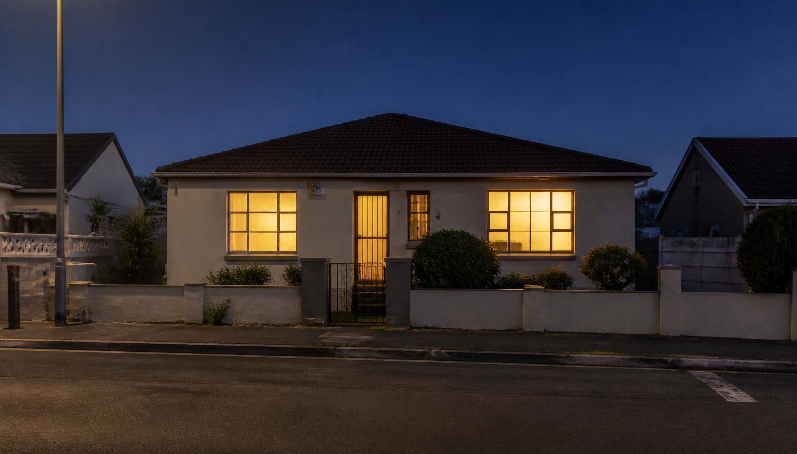 A home at dusk with the lights just come on